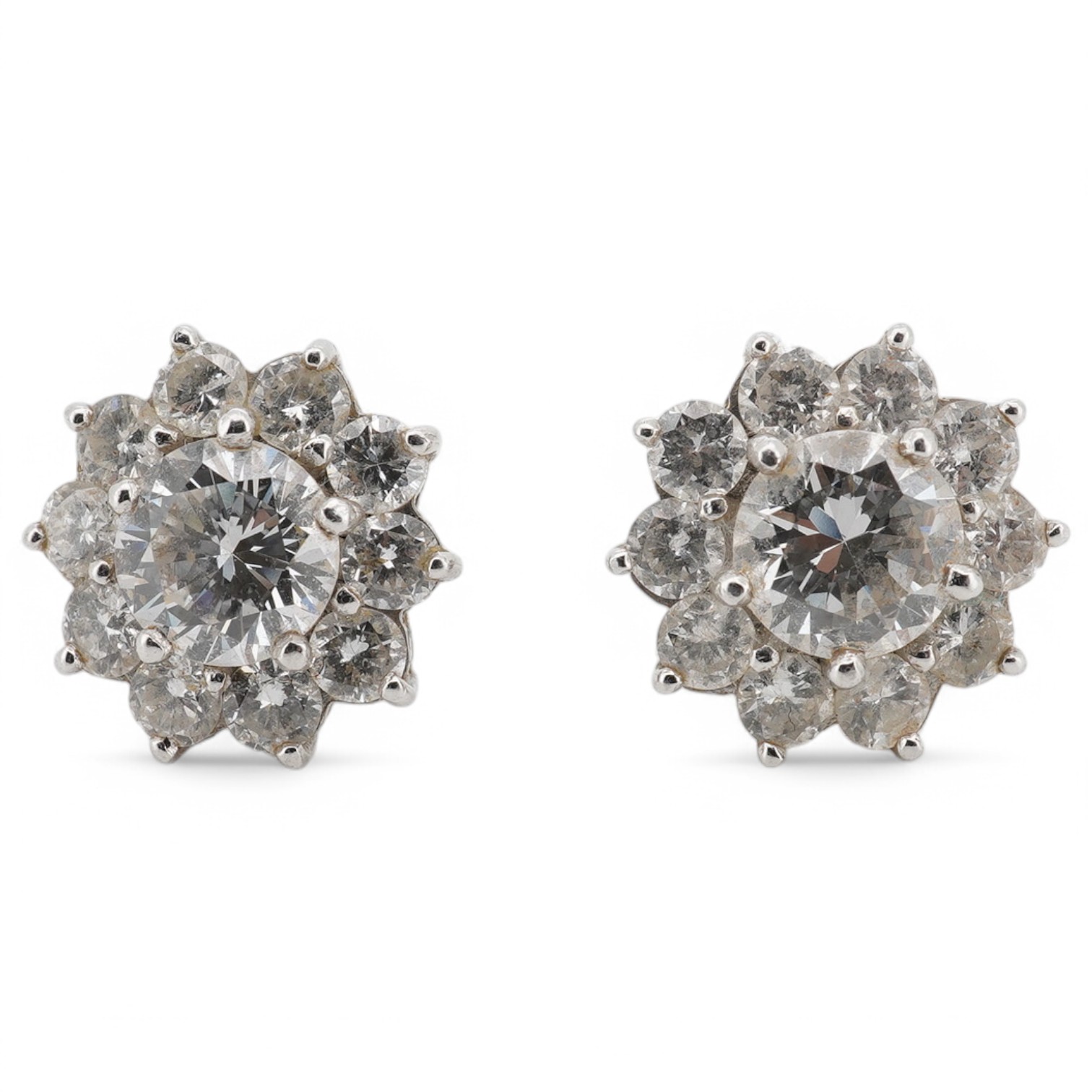 A pair of white metal (stamped 750) and diamond cluster set flower head ear studs, the central stone diameter approximately 6.5mm, overall diameter 9mm, gross weight 2.8 grams, no butterflies. Condition - fair to good